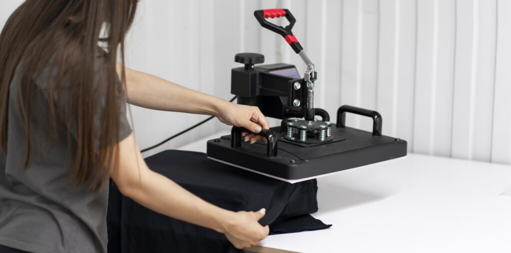 girl makes new craft t-shirt with textile print using press printer machine