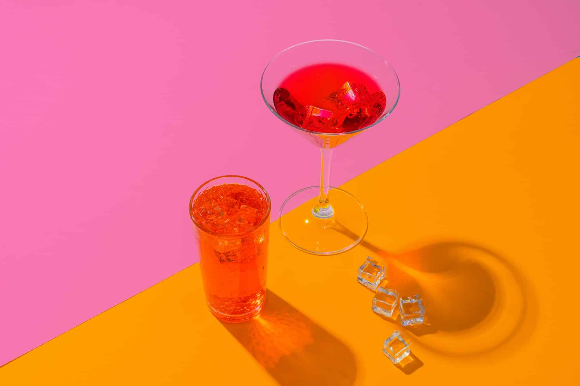 Cold and refreshing cocktails on color background